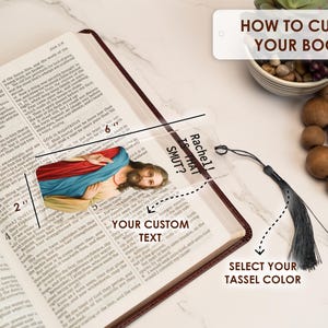 May include: A clear acrylic bookmark with a religious image and the text "Rachel! Is That Smut?"  The bookmark is 6 inches long and 2 inches wide. It has a black tassel.