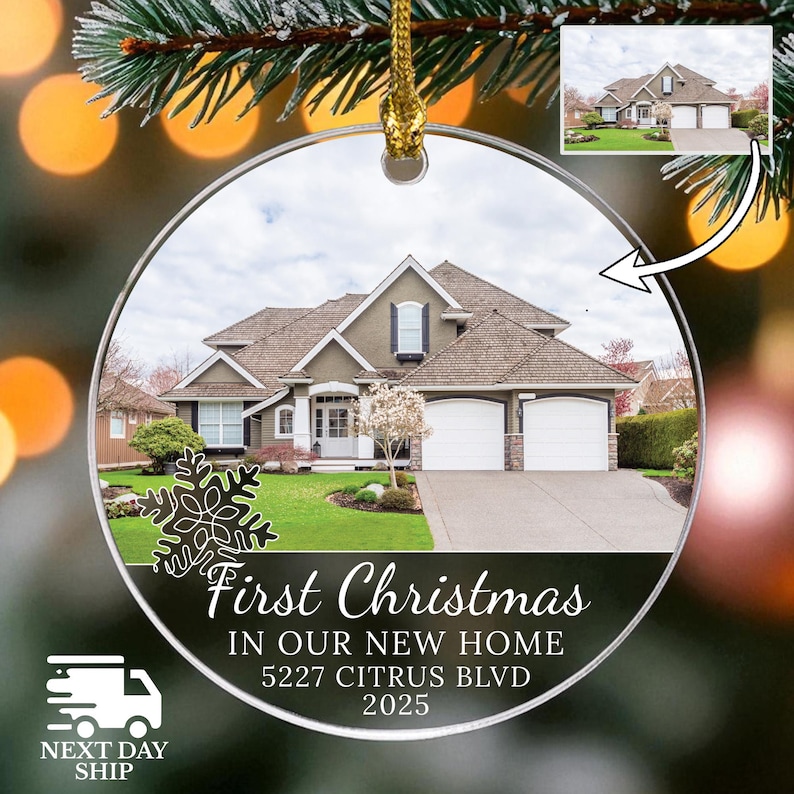 May include: Clear, round Christmas ornament with a house photo inside. The ornament has the text "First Christmas In Our New Home 5227 Citrus Blvd 2025". A snowflake design is on the left side. A small image of the house is in the upper right.