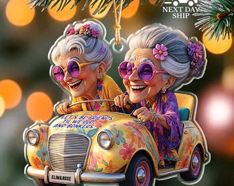 May include: A clear acrylic ornament featuring two smiling elderly women in a yellow car decorated with flowers. The car has the text "LET'S BE FRIENDS TIL WE OLD AND BONKERS" and "ELIN&ROSE". The women wear sunglasses and floral headbands.