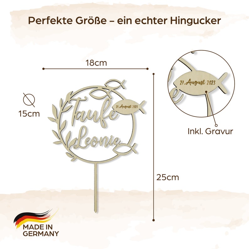 May include: A wooden cake topper, 25 cm tall, features the words "Taufe Leonie" and a date. The topper includes a fish and leaf design, with the text "Made in Germany". The topper is 18 cm wide.