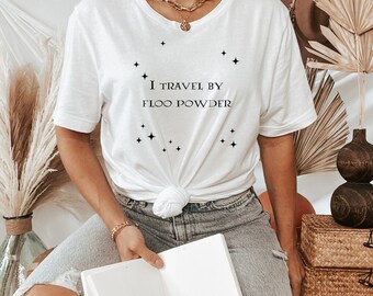 May include: White t-shirt with the text "I travel by Floo Powder" and a constellation of stars printed on the front.