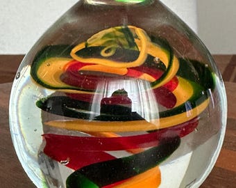Art glass swirl paperweight yellow  green red.
