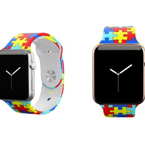 Puede incluir: Dos relojes Apple con correas de diferentes colores. Las correas son de silicona y presentan un patr&oacute;n de piezas de rompecabezas en azul, amarillo, rojo y blanco. El reloj de la izquierda tiene una caja plateada y el reloj de la derecha tiene una caja dorada.