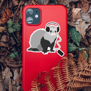 Ferret sticker on a red phone case in forest