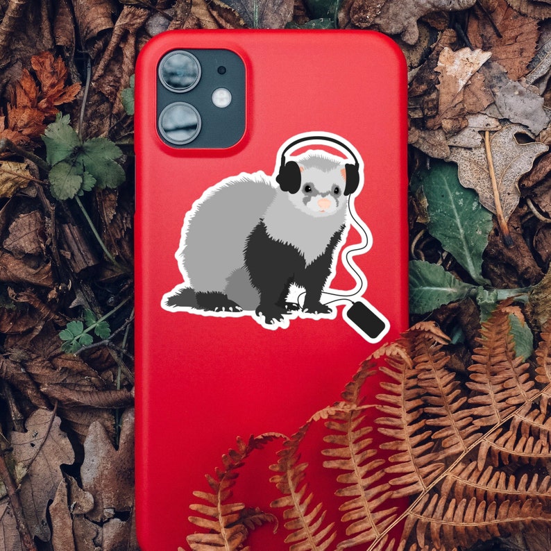 Ferret sticker on a red phone case in forest