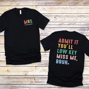 a couple of t - shirts sitting on top of a wooden floor