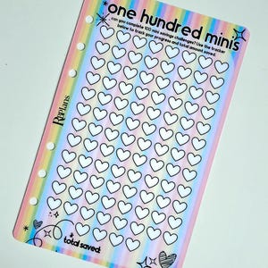 May include: A rectangular savings tracker insert with a pastel rainbow striped background. It features the text "one hundred minis" and "total saved," along with 100 small heart outlines for tracking progress. The left side has six punched holes.