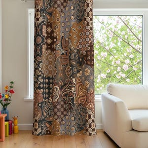 May include: A floor-length curtain featuring a patchwork design with various brown, black, and grey paisley and geometric patterns. The fabric displays a repeating motif of intricate swirls, teardrop shapes, and small floral-like elements across the surface.