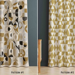May include: Two patterned curtains. Pattern #1 has a geometric design in black, gold, grey, and white. Pattern #2 features a repeating triangle pattern in gold and white. The curtains are shown against a dark teal wall.