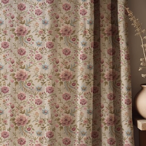 May include: Floral patterned curtain featuring a repeating design of pink roses, small blue flowers, and green leaves on a beige background. The curtain is made of a textured fabric and is partially drawn, with vertical folds visible.