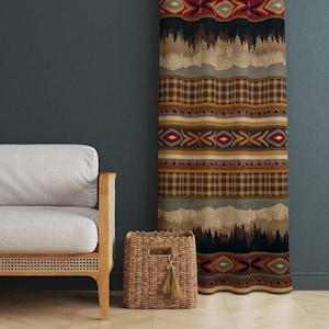 May include: A patterned curtain with a mountain and forest design. The curtain features horizontal stripes with plaid, geometric, and landscape patterns in shades of brown, red, and green. A woven basket with a tassel sits in front of the curtain.