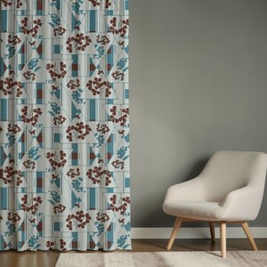 May include: A curtain panel featuring a geometric pattern of white triangles and vertical stripes in shades of teal and brown. The design includes repeating floral motifs in dark brown and light blue, creating a structured, layered visual effect.