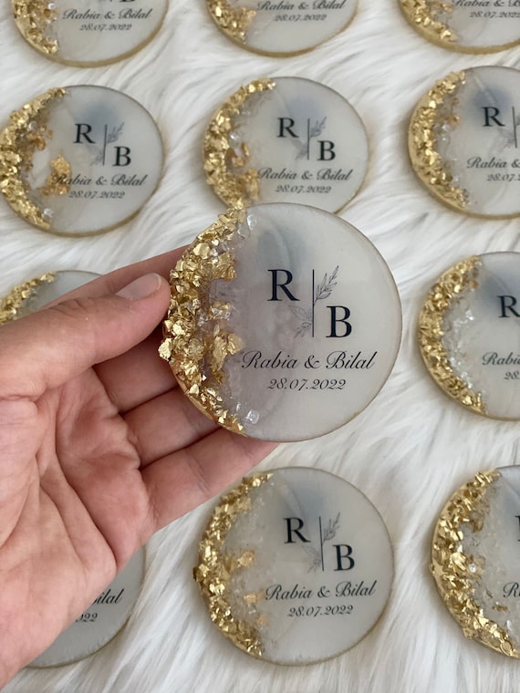 Custom epoxy-domed wedding magnets that double as elegant keepsakes — a step above the usual paper favor, with a glossy, jewel-like finish guests actually keep.