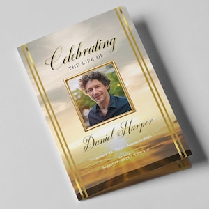 May include: A memorial service booklet with a gold border and a photograph of a man. The booklet includes the text "Celebrating the Life of Daniel Harper" and the dates "January 24, 1970 - August 1, 2024".