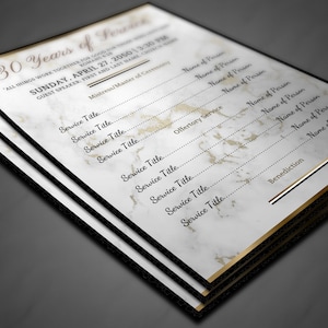May include: A white and gold marble-patterned program for a 30-year anniversary celebration. The program includes the date, time, and names of the people participating in the service.