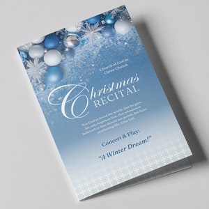 May include: A folded Christmas recital programme with a blue and white gradient background. The programme features text that reads "Christmas Recital" and "A Winter Dream!" with decorative snowflakes and baubles.