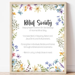 May include: A framed print with the words "Relief Society" in elegant script. The print is surrounded by a floral border of watercolor flowers in shades of blue, yellow, and purple. The text describes the society's purpose.