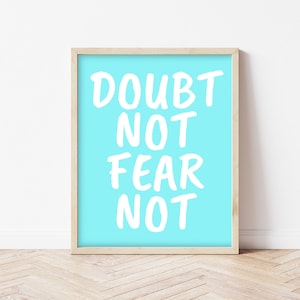 May include: A framed print with a light blue background and white text that reads "DOUBT NOT FEAR NOT".