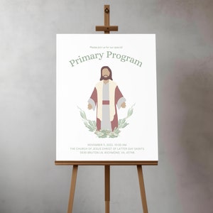 May include: A white poster with the text "Please join us for our special Primary Program" in green text. A cartoon image of Jesus Christ is in the center of the poster. The text "NOVEMBER 5, 2022, 10:00 AM THE CHURCH OF JESUS CHRIST OF LATTER DAY SAINTS 5930 BRUTON LN, RICHMOND, VA, 43798" is at the bottom of the poster.