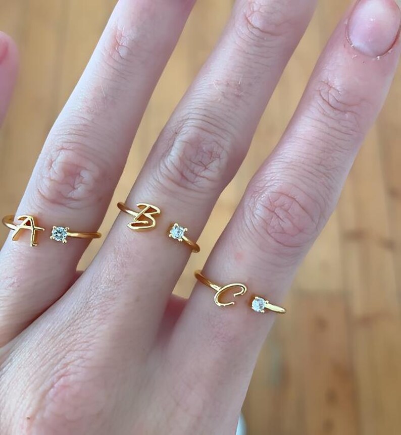 Gold adjustable ring with personalised name initial with cubic zirconia accent. stackable jewellery.