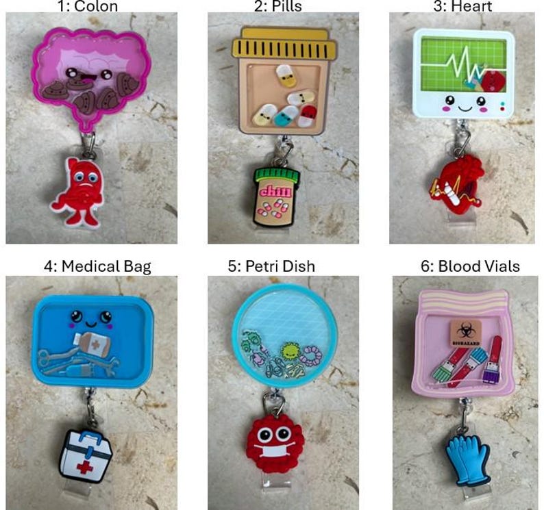 May include: A collection of medical-themed badge reels. The reels feature various designs, including a colon, pills, a heart monitor, a medical bag, a petri dish, and blood vials. Each reel has a unique charm and a retractable cord.