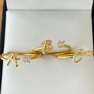 Gold adjustable ring with personalised name initial with cubic zirconia accent. stackable jewellery.