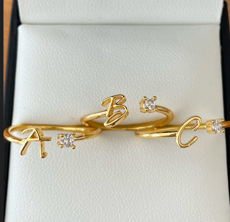Gold adjustable ring with personalised name initial with cubic zirconia accent. stackable jewellery.