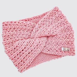 May include: A pink knitted headband with a knotted design. The headband has a small silver tag with the word "Made" on it.