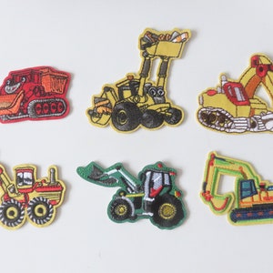 May include: Six embroidered iron-on patches featuring cartoon construction vehicles. The patches are yellow, red, green, and black. The vehicles include a bulldozer, excavator, and a front loader.