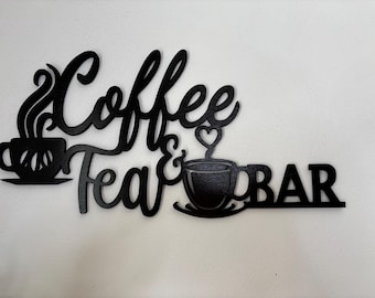 May include: Black wooden sign with the words "Coffee & Tea Bar" in a decorative font. The sign features two coffee cups, one with steam and the other with a heart-shaped steam, adding a touch of charm to the design. Perfect for a kitchen or cafe.
