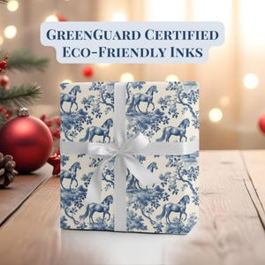 May include: A white gift box with a blue and white horse pattern. The box is tied with a white ribbon and has a "GREENGUARD CERTIFIED ECO-FRIENDLY INKS" label.