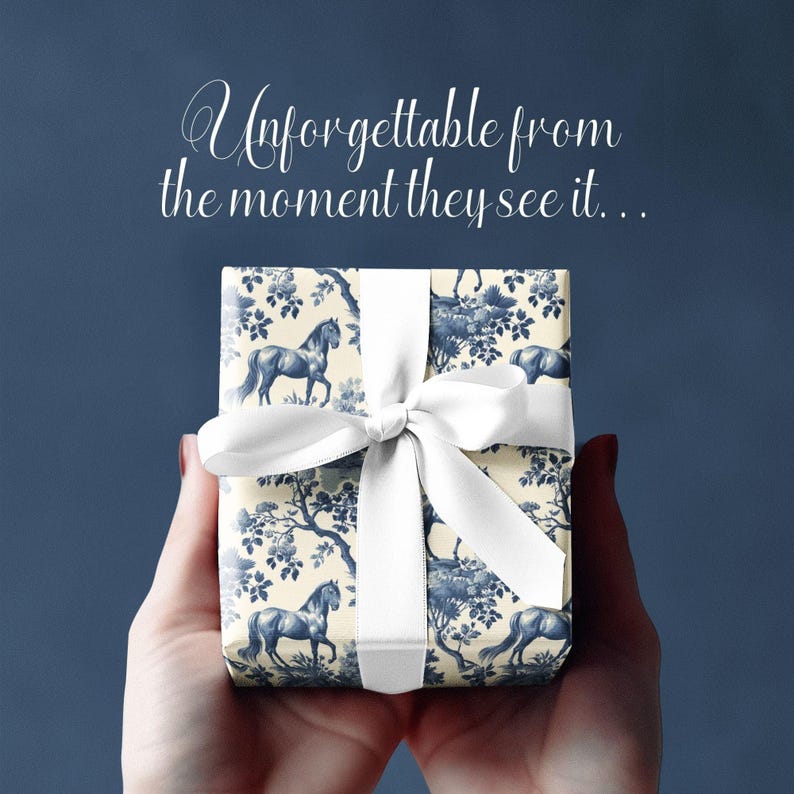 May include: A white gift box with a blue and white horse and floral pattern. The box is tied with a white ribbon and bow. The text "Unforgettable from the moment they see it..." is written above the box.