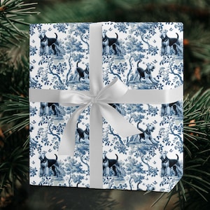 May include: A wrapped gift with blue and white patterned wrapping paper featuring a dog and tree design. The gift is tied with a white ribbon and bow. The background is a dark green.