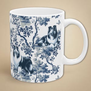May include: White ceramic mug featuring a blue and white toile design with illustrations of a Collie dog and botanical elements. The mug has a curved handle and a smooth surface, perfect for enjoying hot beverages.