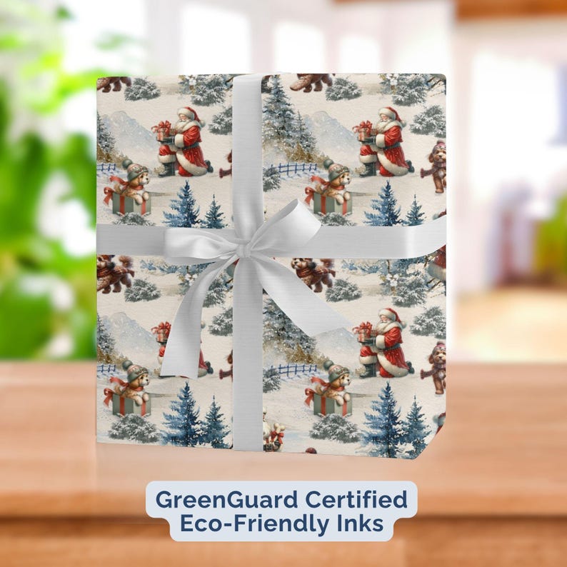 May include: Christmas-themed wrapping paper featuring Santa Claus, teddy bears, and dogs in a snowy landscape. The paper is wrapped around a gift and tied with a white ribbon. The text "GreenGuard Certified Eco-Friendly Inks" is visible.