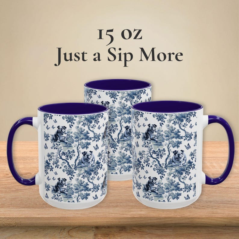 May include: Three 15 oz ceramic mugs with a blue and white pattern of bulldogs and butterflies. The mugs have a blue rim and handle.