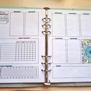 May include: A weekly planner with a calendar, habit tracker, step tracker, and notes section. The planner has a colorful mandala design on the right side.