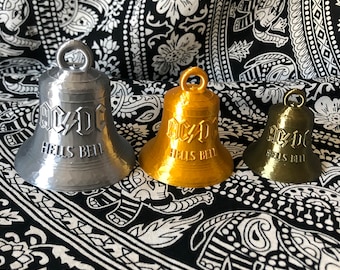 May include: Three metal bells with the AC/DC logo and the words "Hells Bell" inscribed on them. The bells are silver, gold, and bronze.