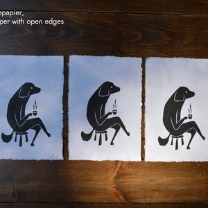 May include: Three black and white illustrations of a dog sitting on a stool and holding a cup of coffee. The illustrations are printed on handmade paper with open edges.