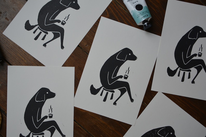 May include: Four black and white illustrations of dogs sitting on stools and holding mugs. Each dog is depicted in a simple, stylized manner, with a focus on the dog's body and the mug.