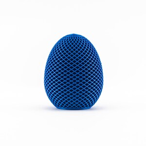 May include: A blue egg-shaped object with a geometric pattern. The object is made of a material that appears to be plastic or rubber.