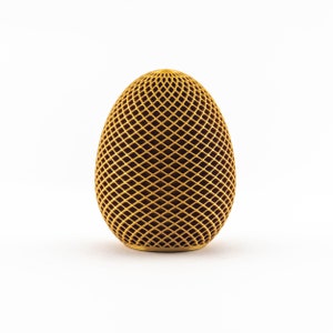 May include: A gold egg-shaped object with a geometric pattern.