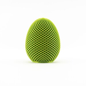May include: A green, geometric egg-shaped object with a diamond pattern.