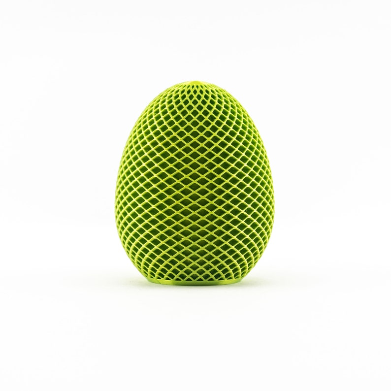 May include: A green, geometric egg-shaped object with a diamond pattern.