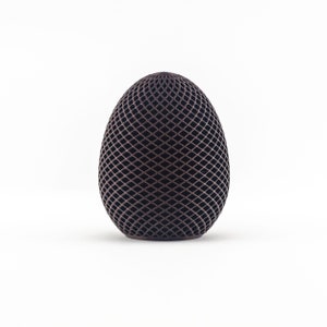 May include: A dark brown egg-shaped object with a geometric pattern of intersecting lines.