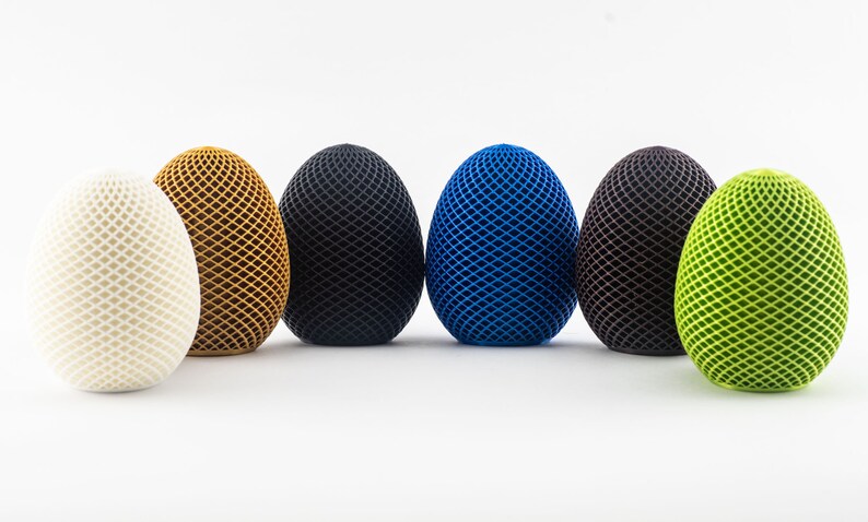 May include: Six decorative eggs with a geometric pattern. The eggs are white, brown, black, blue, brown, and green.