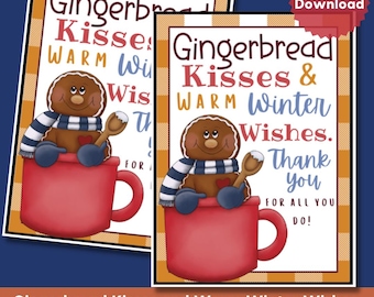 May include: A rectangular printable gift tag featuring a brown gingerbread character wearing a blue and white striped scarf and blue mittens, sitting inside a red mug. The text reads Gingerbread Kisses & WARM Winter Wishes. Thank you FOR ALL YOU DO!