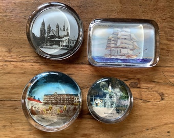 Set of 4 antique paperweights with scenes.