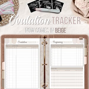 Peut inclure: Reliure de suivi de l'ovulation et de la grossesse beige et blanche avec un c&oelig;ur et le texte "Ovulation Tracker" et "Pregnancy Tracker".