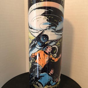 May include: A stainless steel tumbler with a black background and a colorful image of the Starship Enterprise from Star Trek. The image also features two characters from the show, Captain Kirk and Spock, in space.